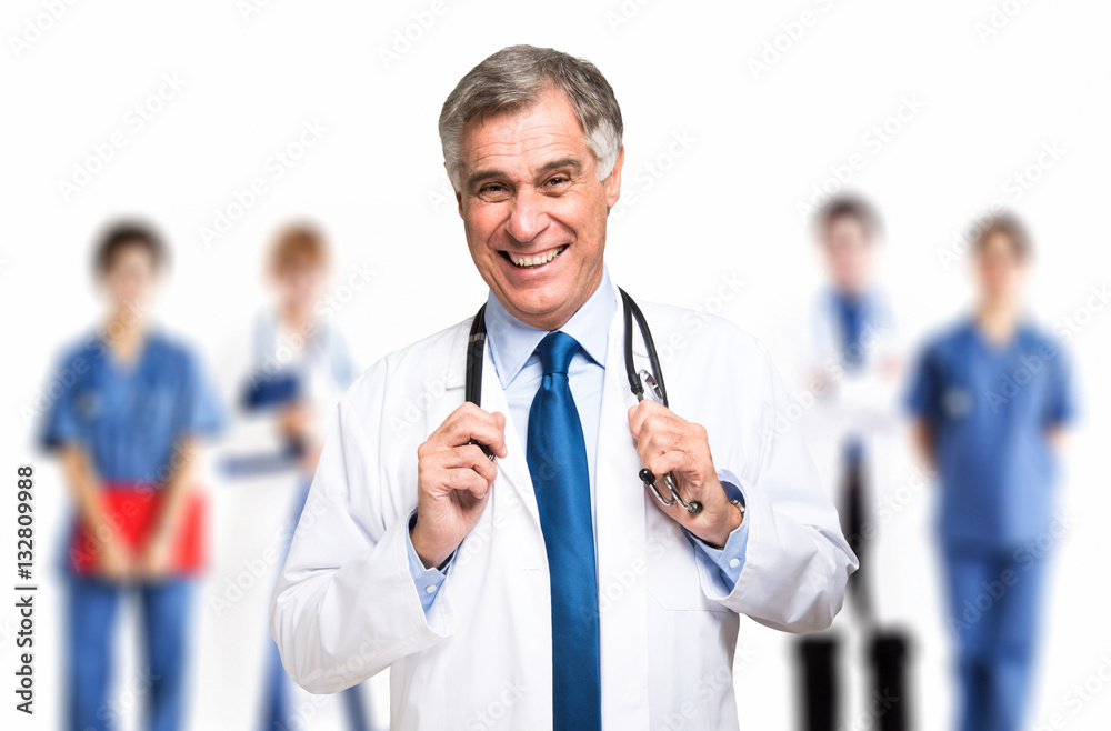 Smiling doctor in front of a group of doctors Smiling doctor in front of a group of doctors