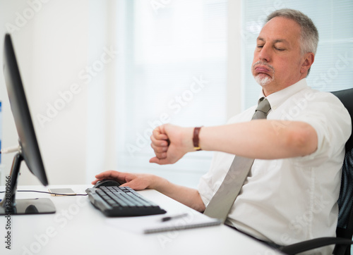 Obraz na plátne Impatient businessman watching his wrist watch in the office