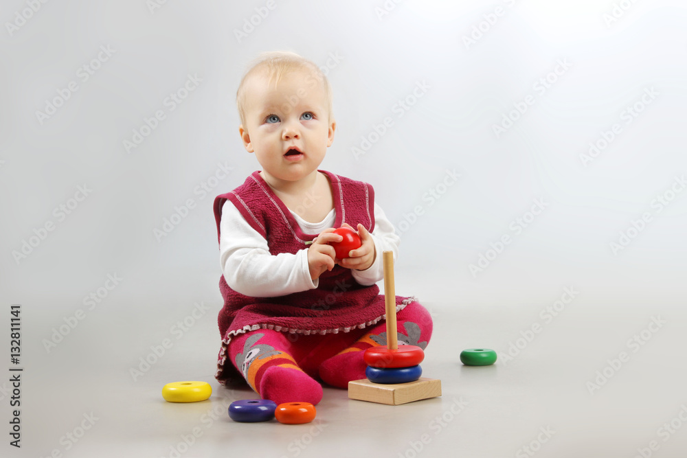 Shot of an adorable baby girl in red clothes playing with some wooden toys. Shot of an adorable baby girl in red clothes playing with some wooden toys.