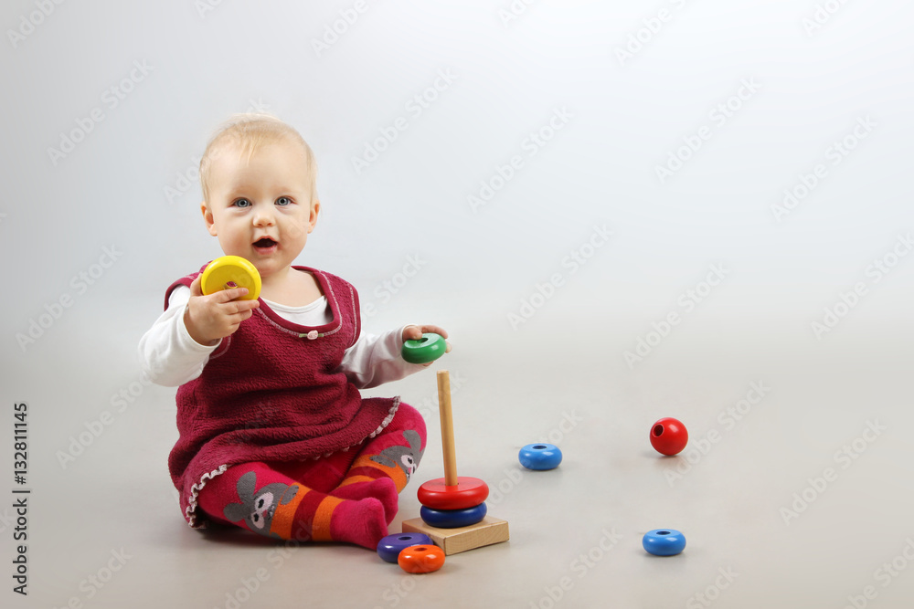 Shot of an adorable baby girl in red clothes playing with some wooden toys. Shot of an adorable baby girl in red clothes playing with some wooden toys.