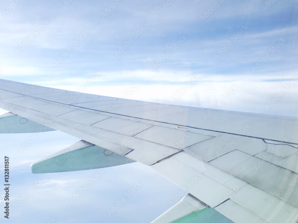 Fototapeta premium clouds and sky as seen through window of an aircraft