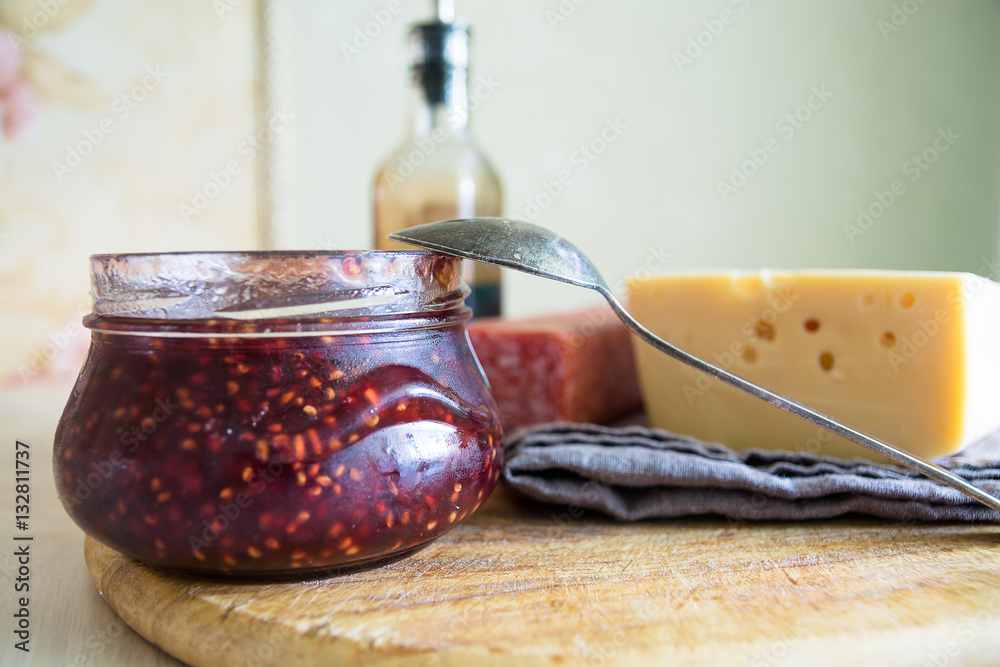 Big piece of cheese, salami and jar with jam. Big piece of cheese, salami and jar with jam.
