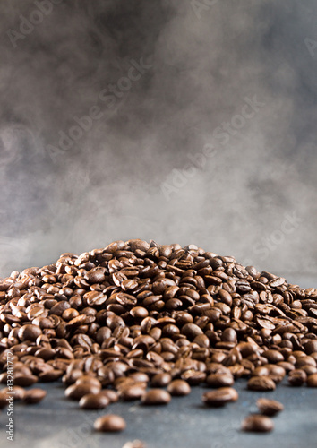 Heap of hot roasted coffee beans with steam
