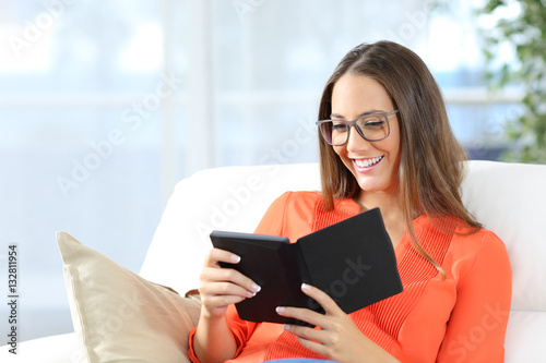 Woman reading ebook with glasses