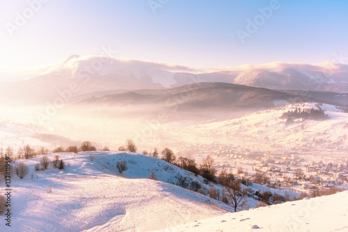 Soft light of fresh winter sunrise at the mountains, alpine countryside landscape © larauhryn