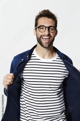 Excited man showing striped top, smiling