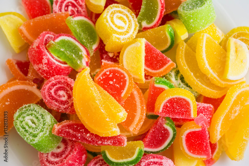 Multicolored fruit jellies on a white plate. Delicious and beautiful dessert.