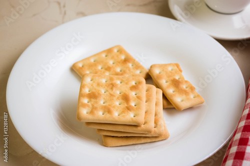 Crackers on a white plate and coffee. Tasty and nutritious breakfast.