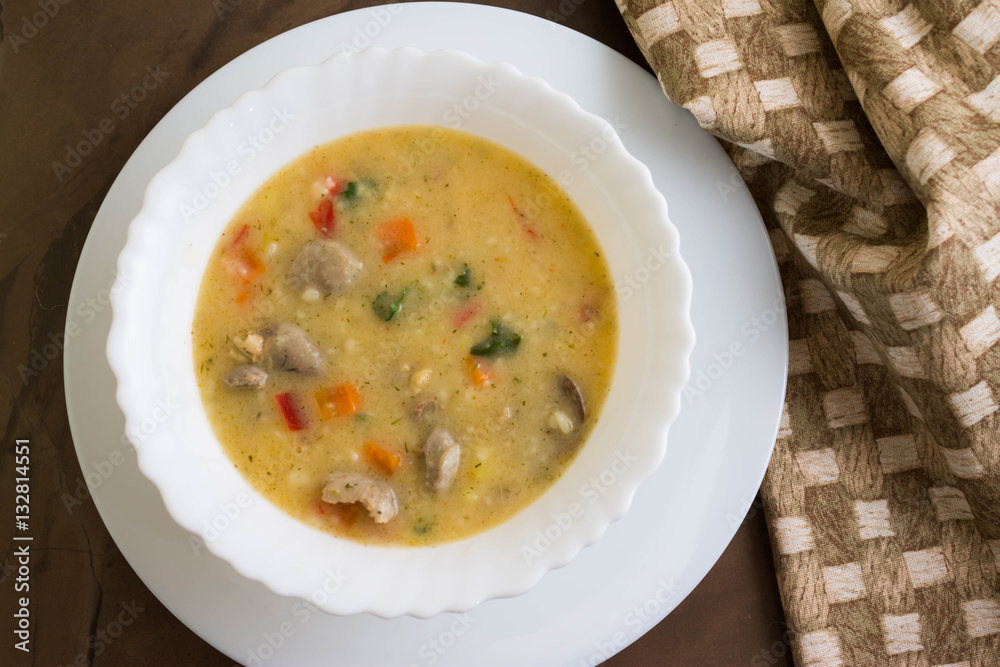 Flour soup with chicken giblets in a white bowl
