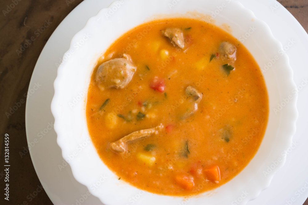 Tomato soup with chicken giblets in a white bowl Tomato soup with chicken giblets in a white bowl