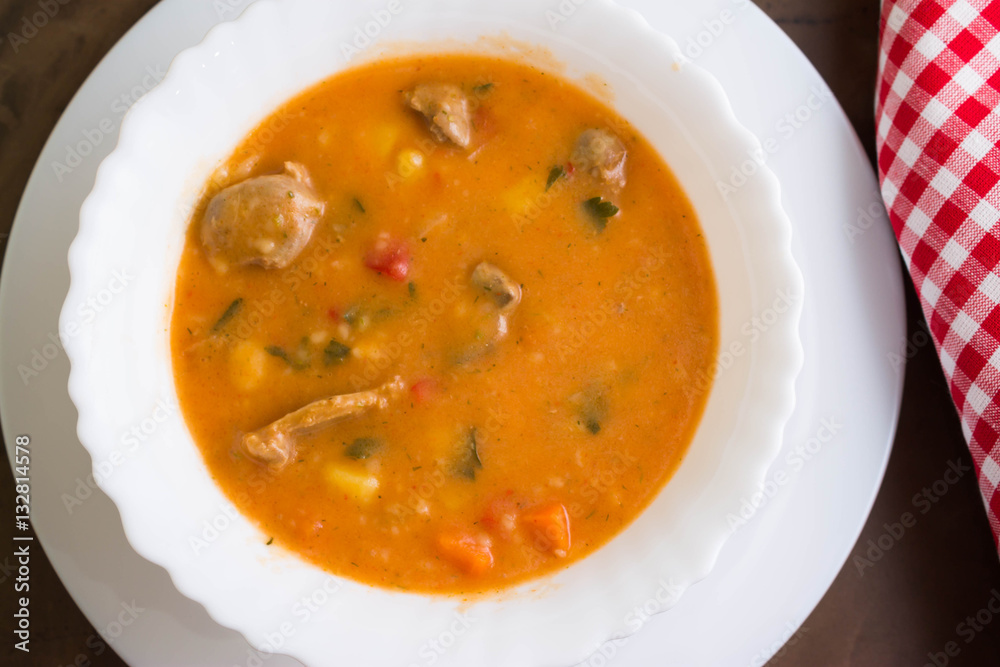 Tomato soup with chicken giblets in a white bowl Tomato soup with chicken giblets in a white bowl