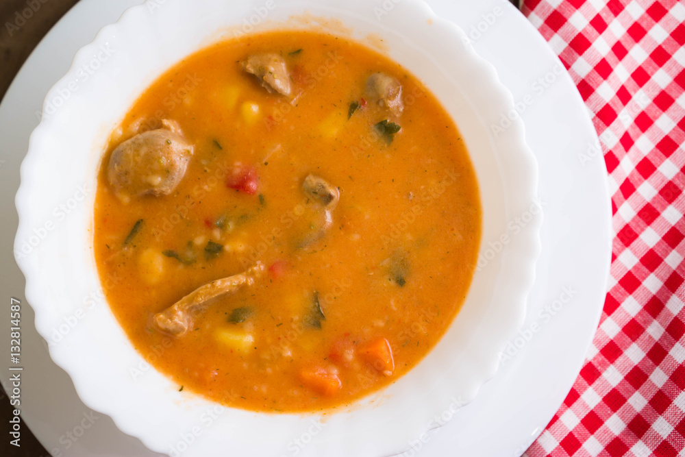 Tomato soup with chicken giblets in a white bowl Tomato soup with chicken giblets in a white bowl