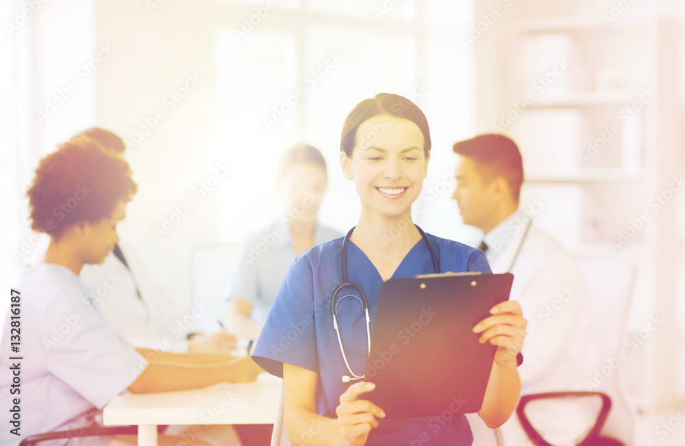 Fototapeta premium happy doctor over group of medics at hospital
