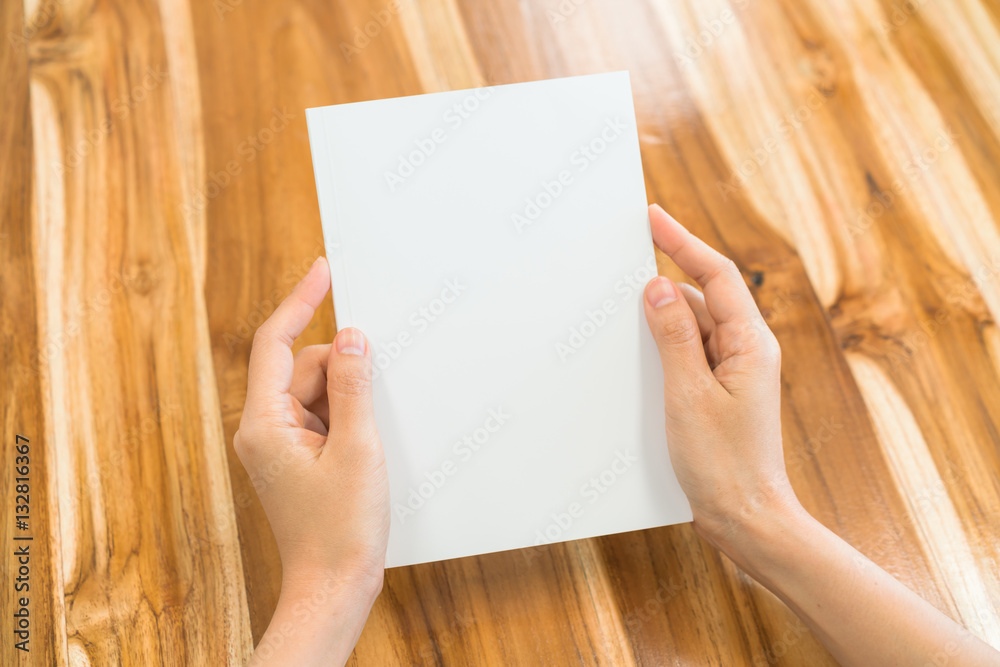 Hands open book on wood table . Hands open book on wood table .