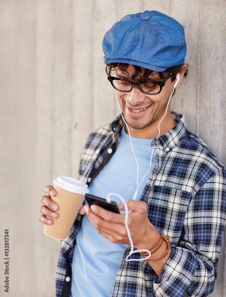man with earphones and smartphone drinking coffee man with earphones and smartphone drinking coffee