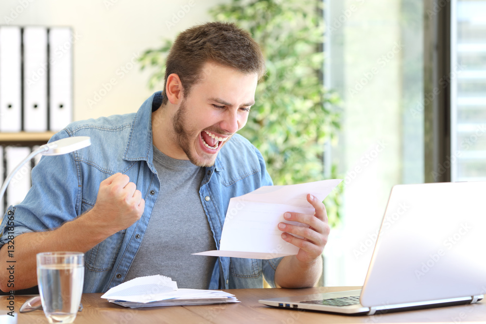 Excited entrepreneur reading a letter Excited entrepreneur reading a letter
