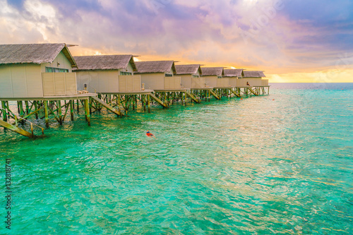 Beautiful water villas in tropical Maldives island at the sunset © jannoon028