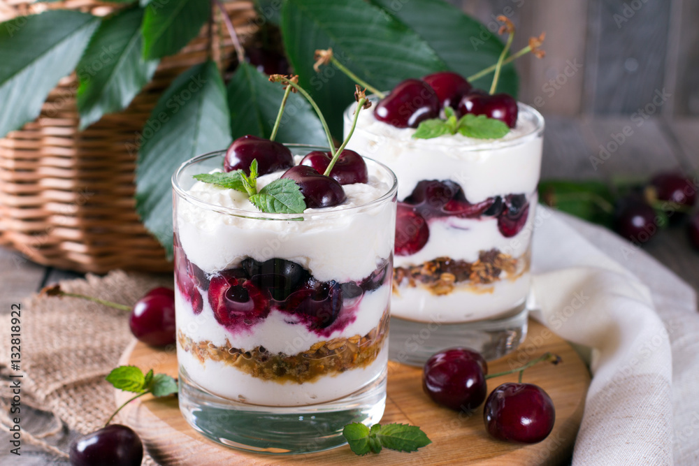 Dessert with a cherry and oat flakes in a glass Dessert with a cherry and oat flakes in a glass