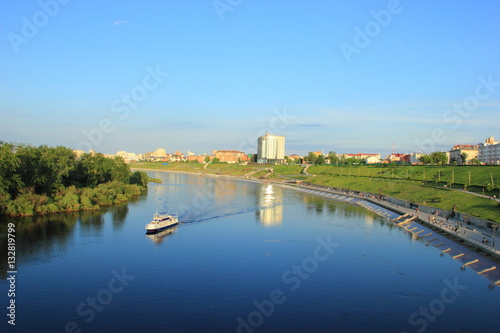 The ship floats on the river Tour along the waterfront, in the centre of Tyumen city in clear weather © Vladimir