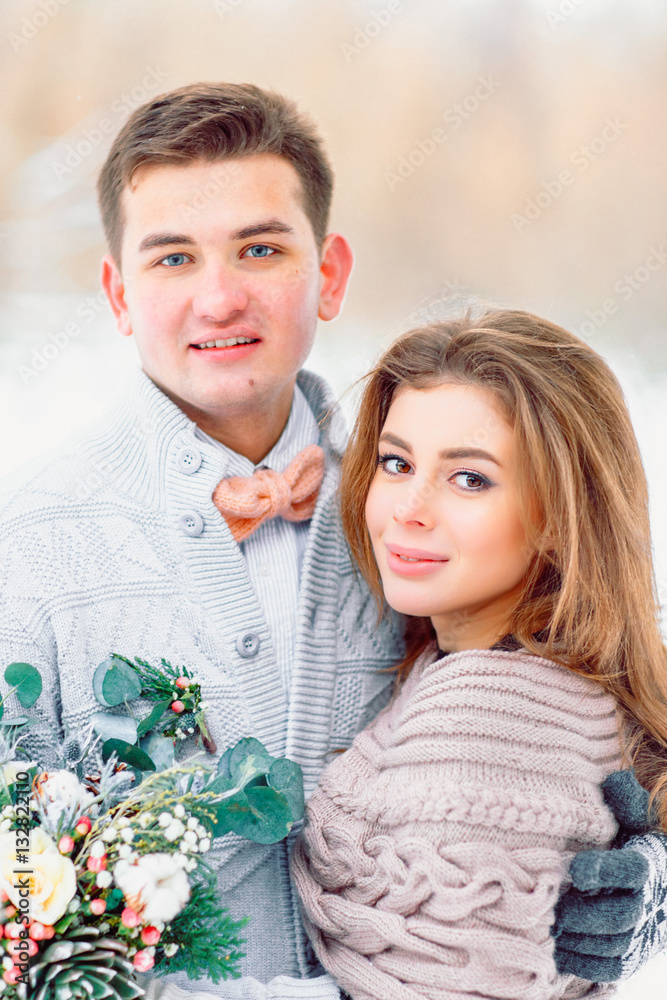 Beautiful bride and groom looking at the camera. Winter wedding. Beautiful bride and groom looking at the camera. Winter wedding.