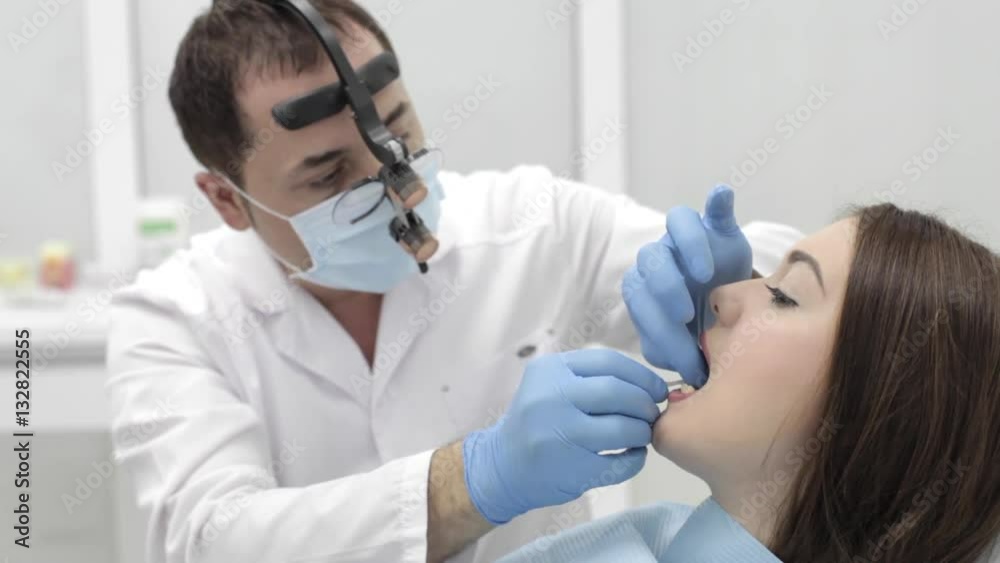 Dentist makes the procedure. Beutyful young woman visit a modern dental clinic. Dentist makes the procedure. Beutyful young woman visit a modern dental clinic.
