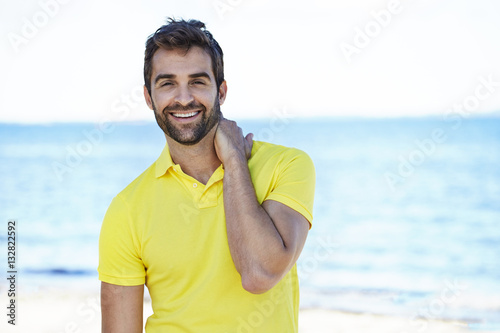 Smiling guy in yellow polo shirt, portrait