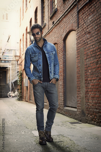 Man wearing denim jacket and jeans in street