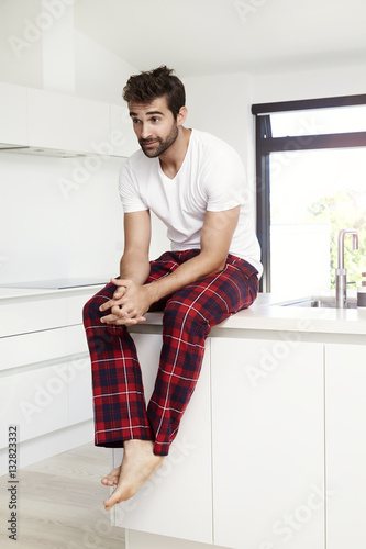 Pajama guy in kitchen, looking away