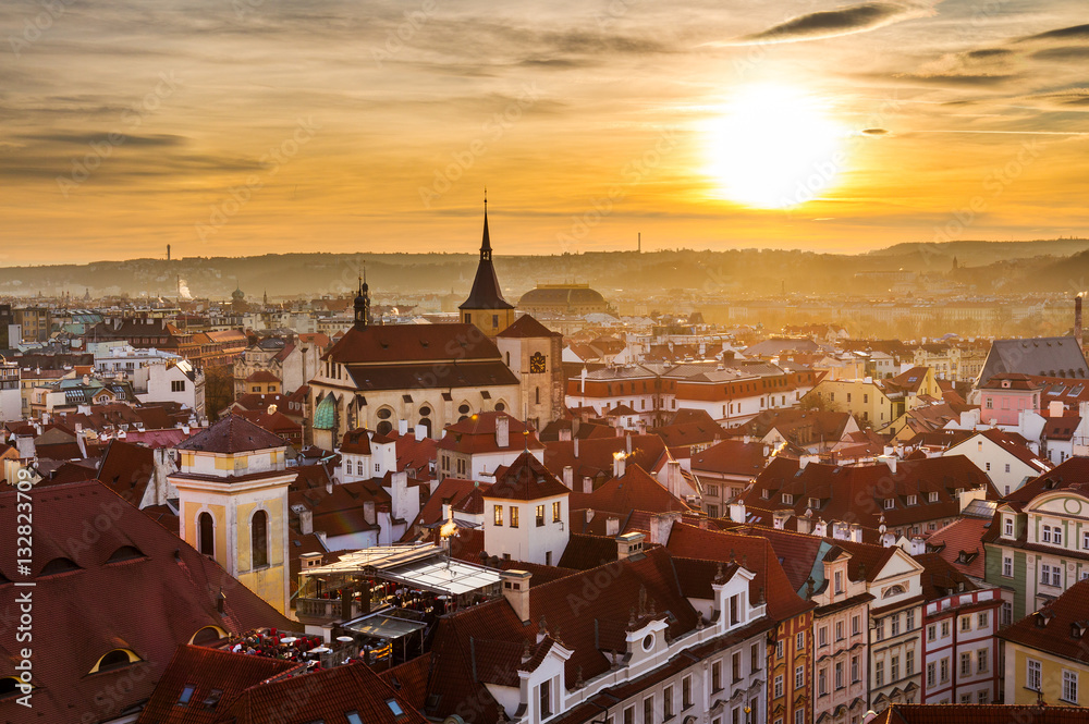 St. Jilji Church and houses with traditional red roofs in Prague Old Town Square at sunset, Czech Republic