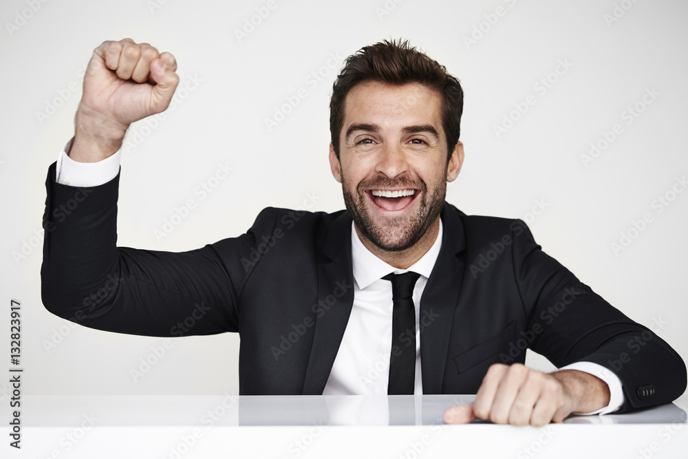 Businessman punching air in studio, portrait Businessman punching air in studio, portrait