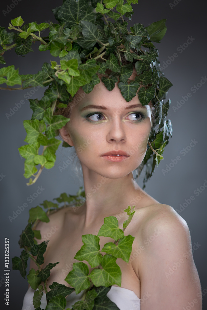 Fototapeta premium young woman in a wreath of leaves