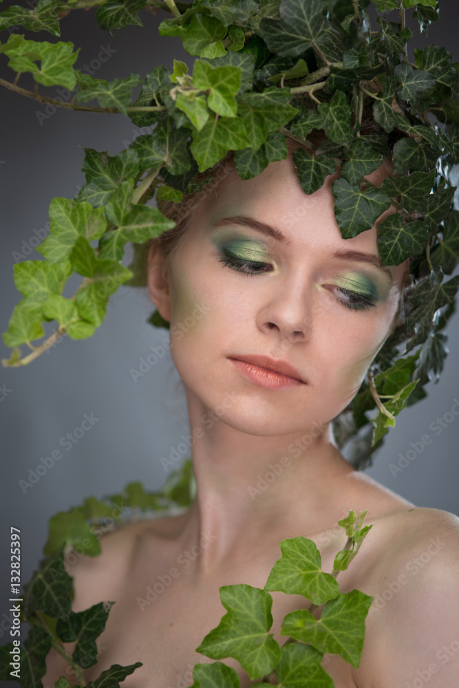 young woman in a wreath of leaves young woman in a wreath of leaves