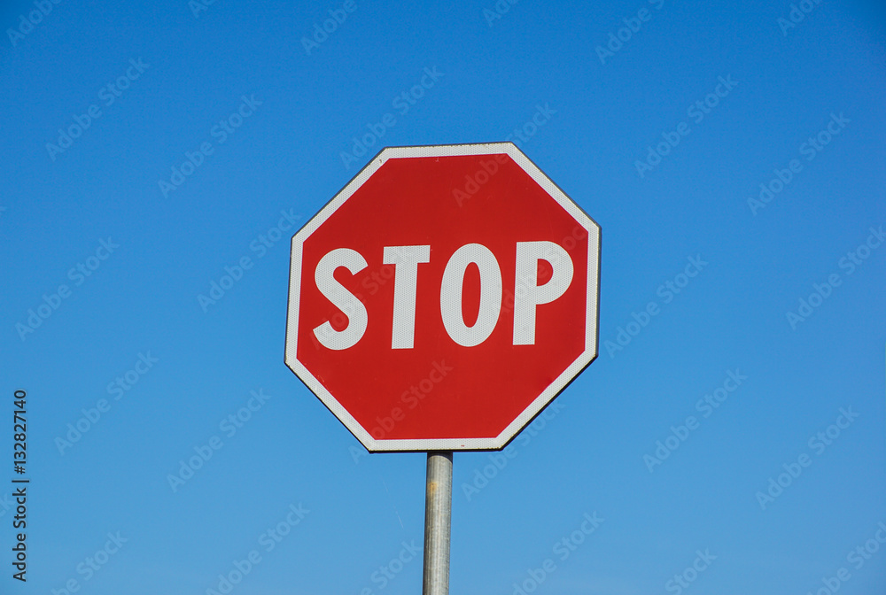 Red Stop Sign with Blue Sky Background Red Stop Sign with Blue Sky Background