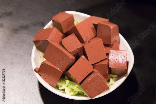 фотографія Plate of hardened pig blood in cubes, delicacy among Chinese
