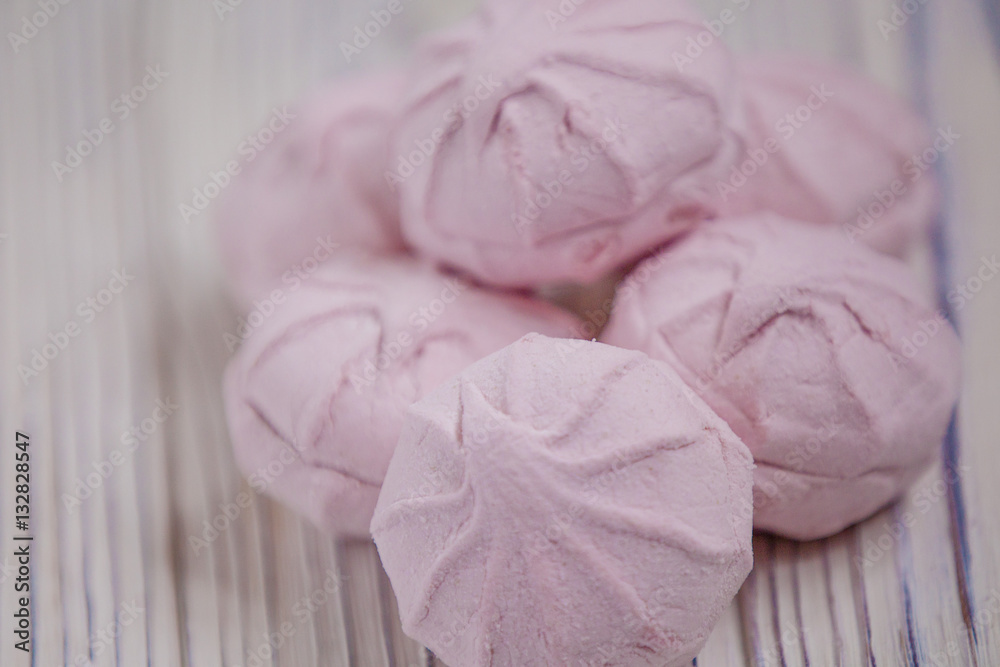 pink marshmallow - zephyr on a light wooden table pink marshmallow - zephyr on a light wooden table