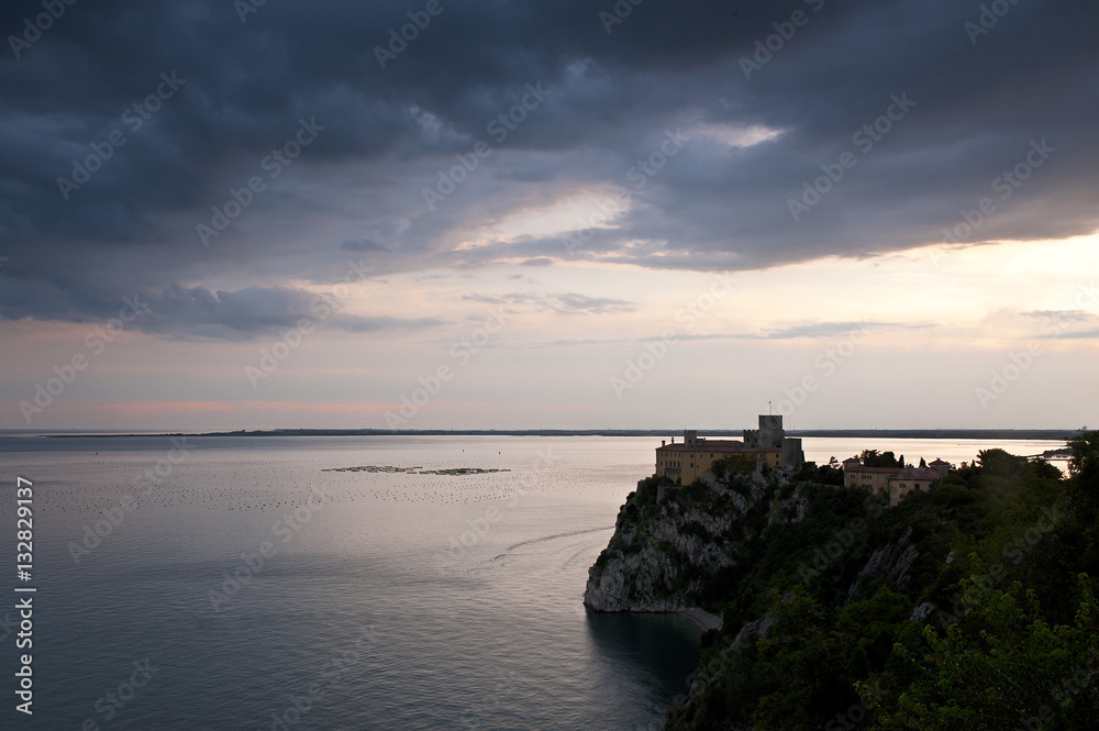 The Duino Castle looks towards the Gulf of Trieste, at sunset.Italy