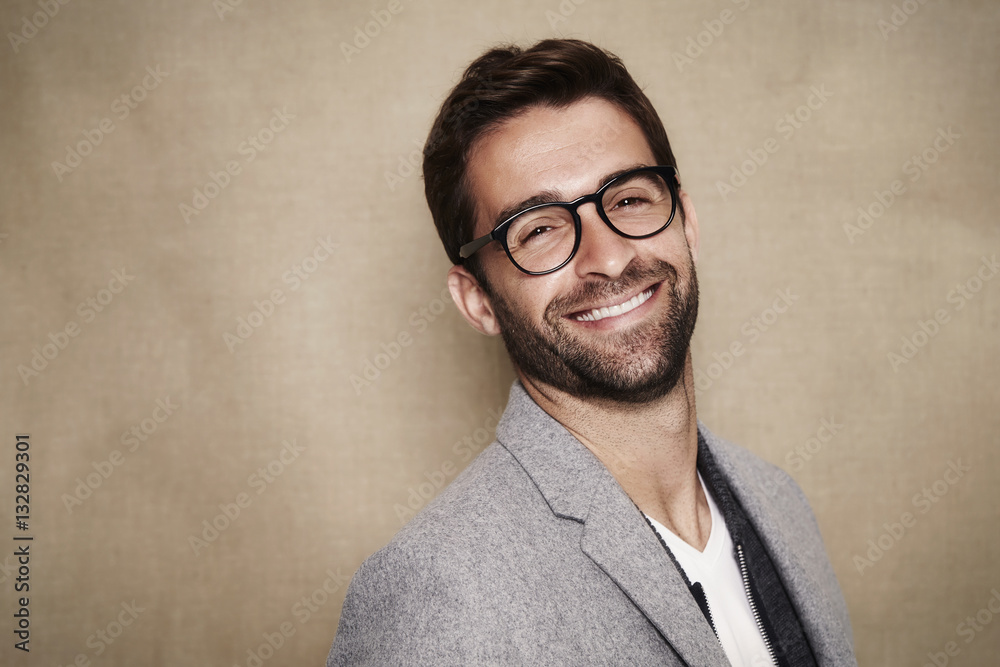 Smiling guy in glasses wearing grey coat Smiling guy in glasses wearing grey coat