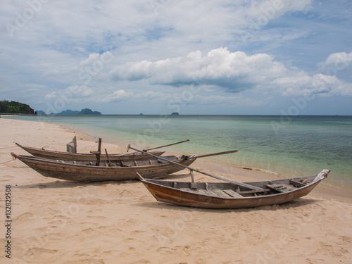 Fishing boats parked on the beach during the day.  6 