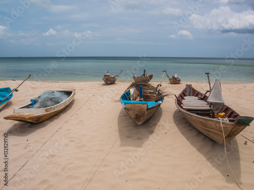 Fishing boats parked on the beach during the day. (6)