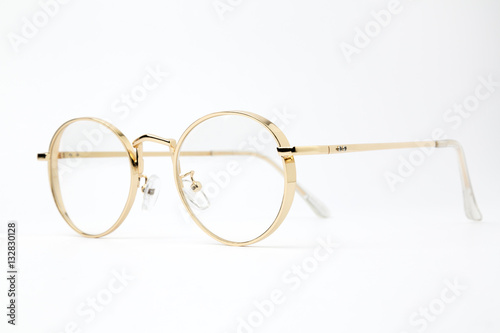 Classic gold round glasses on white background
