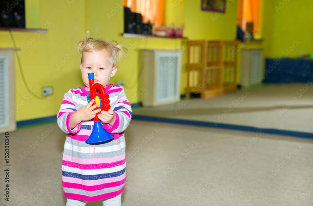 Little child girl playing in kindergarten in Montessori preschool Class. Adorable kid in nursery room. Little child girl playing in kindergarten in Montessori preschool Class. Adorable kid in nursery room.
