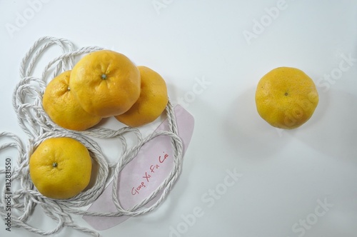 Mandarin oranges isolated on white background with tag Gong Xi Fa Cai photo