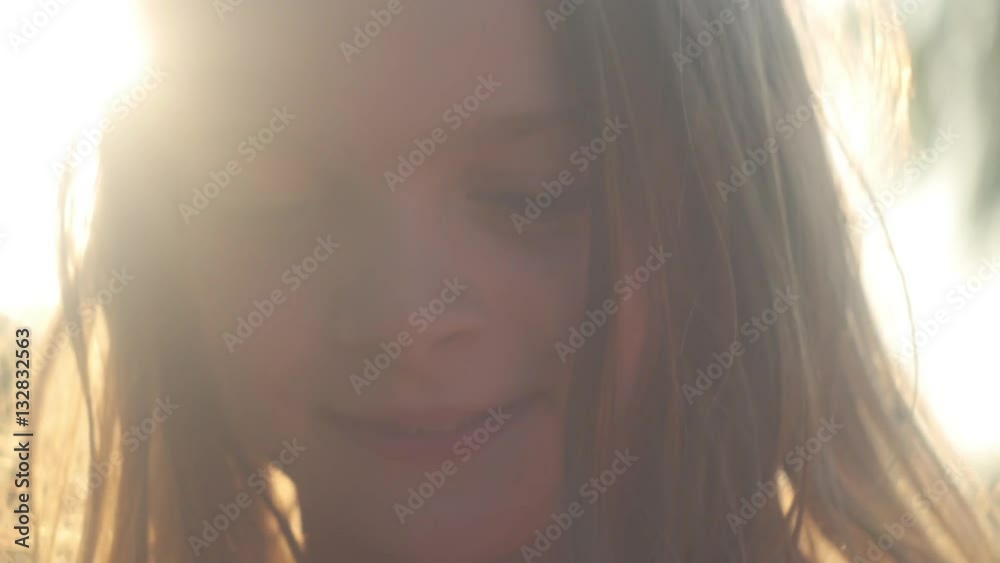 slow motion shot of an authentic truly happy girl in hazy summer sun