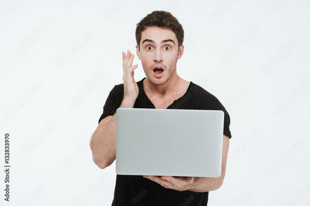 Shocked young man using laptop computer. Shocked young man using laptop computer.
