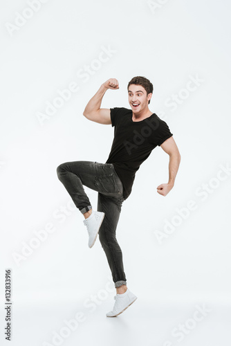 Happy young man posing over white background