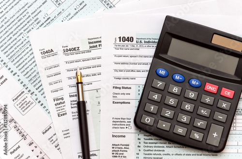 Pen with calculator on tax form. Top View.