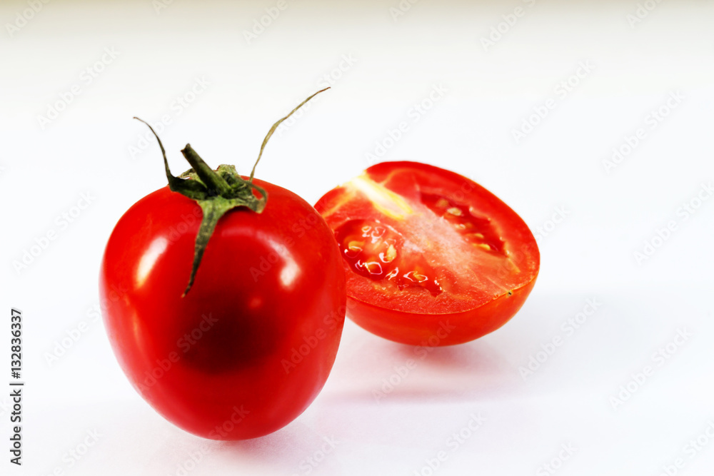 Tomatoes and tomato slices on a white background. Tomatoes and tomato slices on a white background.