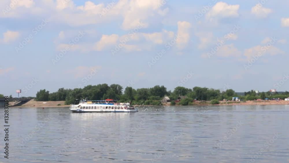 White ship sails on river among many gulls, view from sailing ship White ship sails on river among many gulls, view from sailing ship