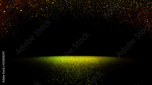 sparkling golden, red and green glitter falling on a flat surface lit by a bright spotlight