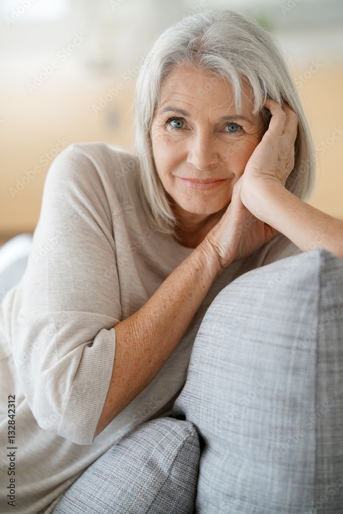 Portrait of senior woman relaxing in sofa Portrait of senior woman relaxing in sofa